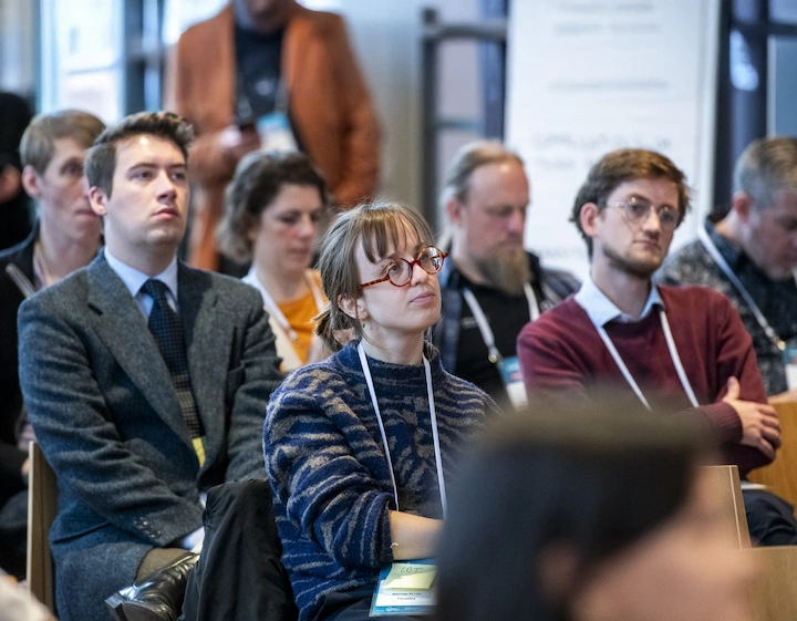 Code & Compliance Community Day 2025: A room of people listening to a panel.